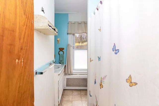 a bathroom with a tub shower and a sink