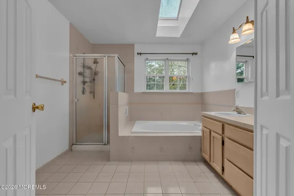 a bathroom with a bathtub and a shower