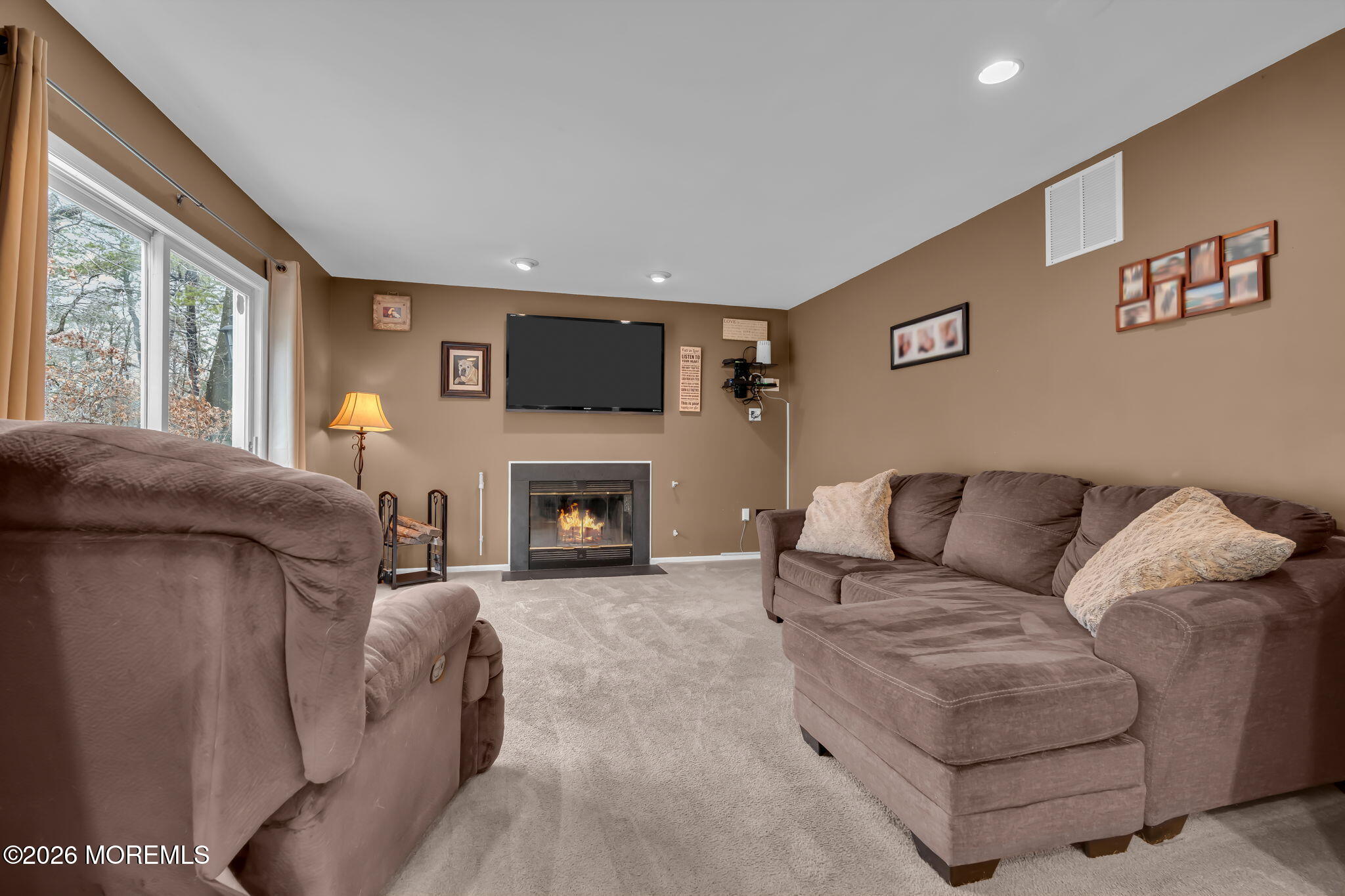 6 Candy Court Jackson, NJ 08527 - Photo 20 of 74 a living room with furniture a flat screen tv and a fireplace