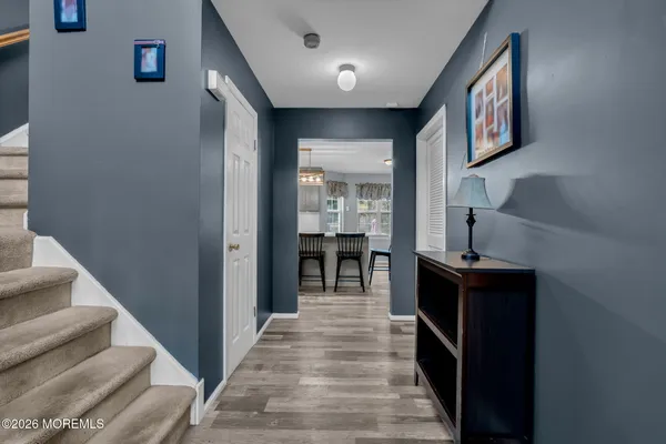 a view of a hallway with wooden floor and entryway