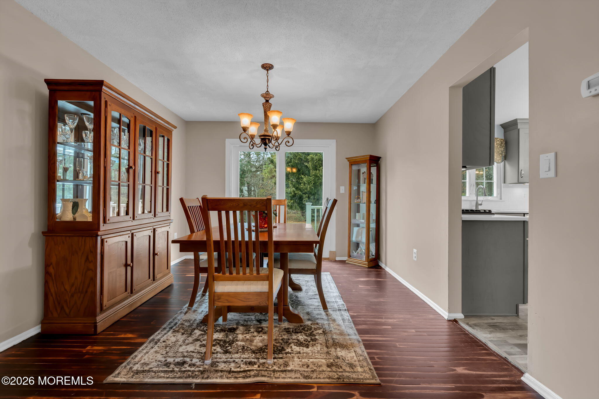 6 Candy Court Jackson, NJ 08527 - Photo 42 of 74 a dining room with wooden floor a chandelier a wooden table and chairs