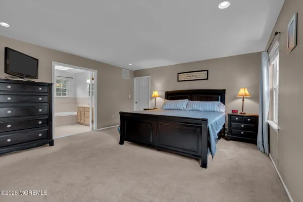 a bedroom with a bed and a television