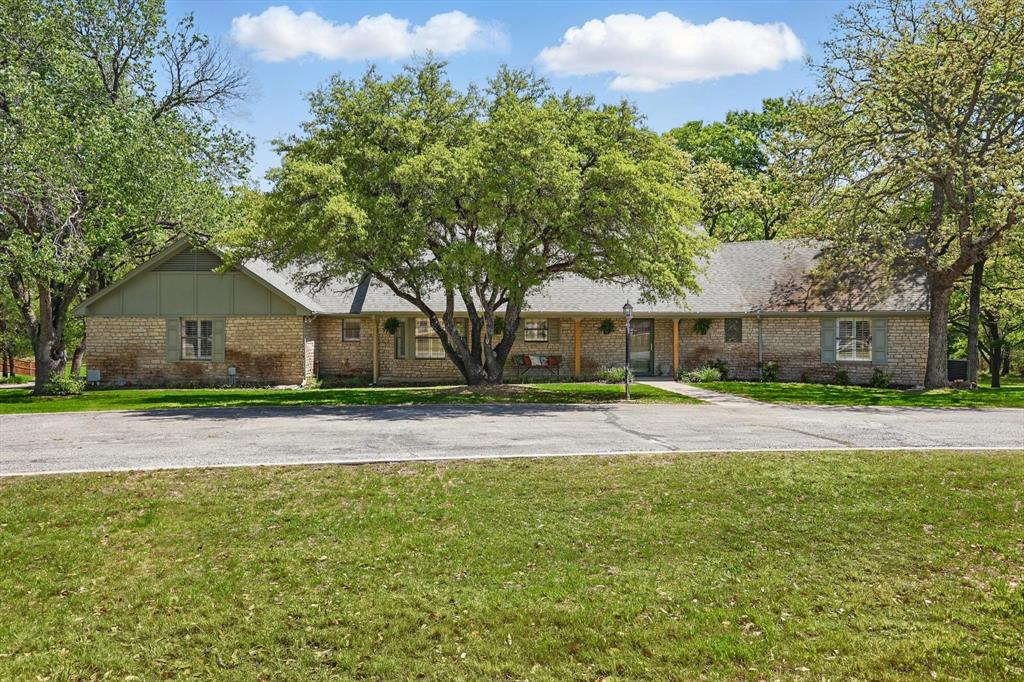 Ranch-style home featuring brick siding and a front yard