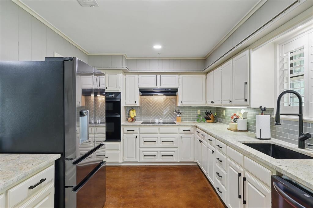 1904 Oak Ridge Trail Bridgeport, TX 76426 - Photo 11 of 34 Kitchen featuring stainless steel appliances, ornamental molding, finished concrete flooring, light stone countertops, and backsplash