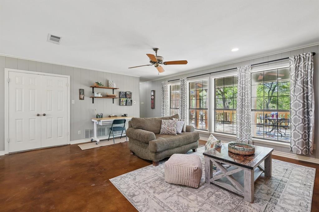 1904 Oak Ridge Trail Bridgeport, TX 76426 - Photo 15 of 34 Living area with a ceiling fan, finished concrete floors, and ornamental molding