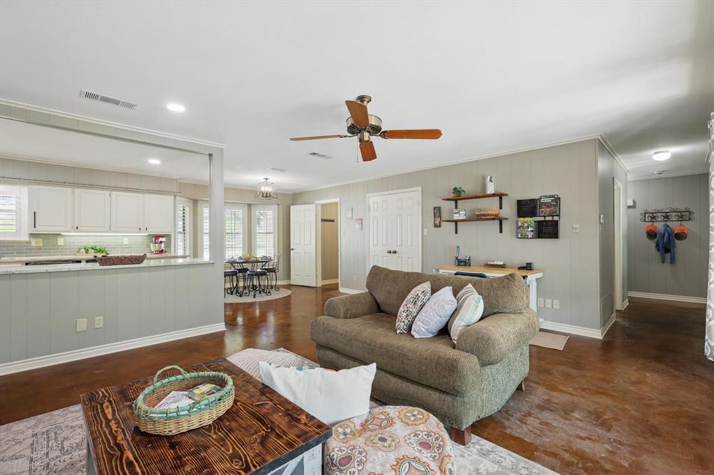 1904 Oak Ridge Trail Bridgeport, TX 76426 - Photo 16 of 34 Living area featuring ornamental molding, ceiling fan, and concrete flooring