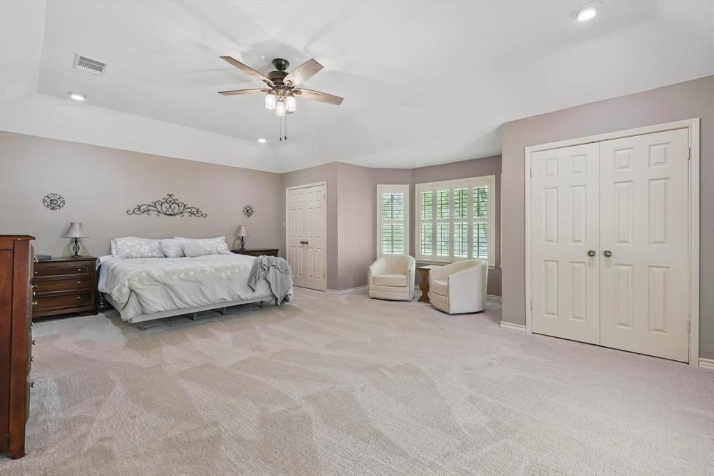 1904 Oak Ridge Trail Bridgeport, TX 76426 - Photo 17 of 34 Bedroom with multiple closets, recessed lighting, light carpet, a ceiling fan, and a tray ceiling