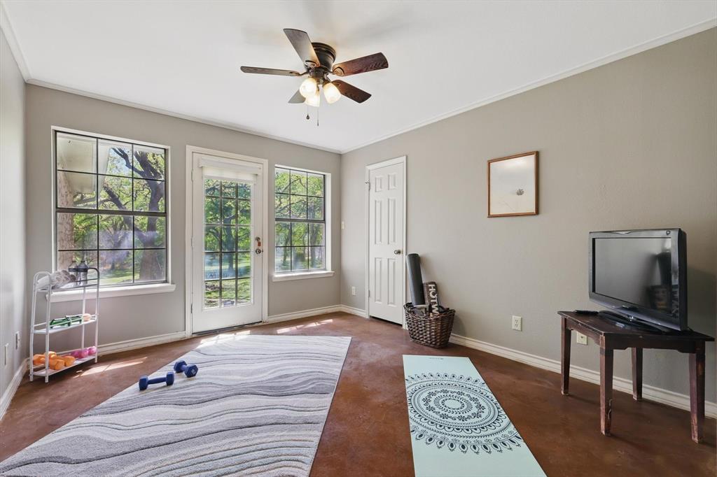 1904 Oak Ridge Trail Bridgeport, TX 76426 - Photo 26 of 34 Bedroom with access to exterior, ceiling fan, and ornamental molding