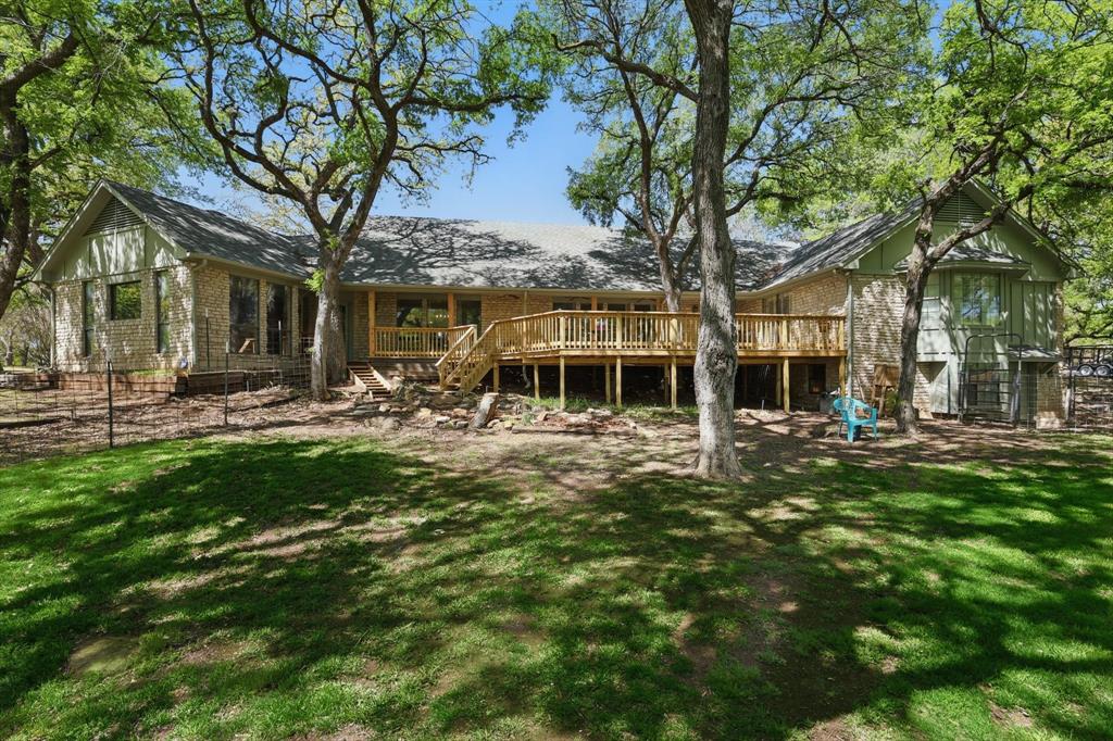 1904 Oak Ridge Trail Bridgeport, TX 76426 - Photo 29 of 34 Back of property with a lawn and a deck