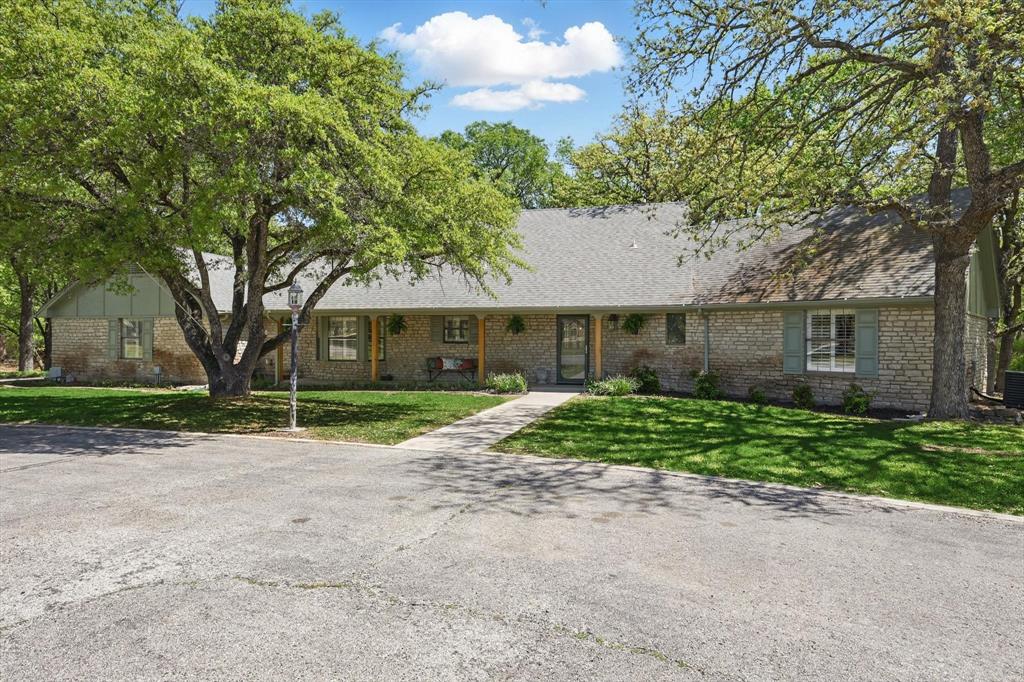 1904 Oak Ridge Trail Bridgeport, TX 76426 - Photo 4 of 34 Single story home with a front lawn, covered porch, and brick siding