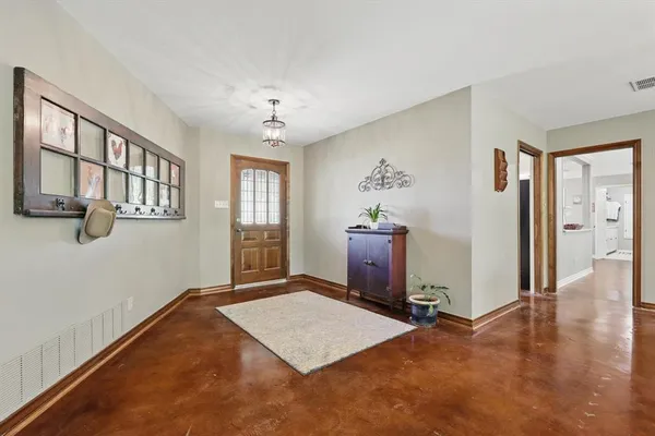 a view of a livingroom with an entryway and chandelier