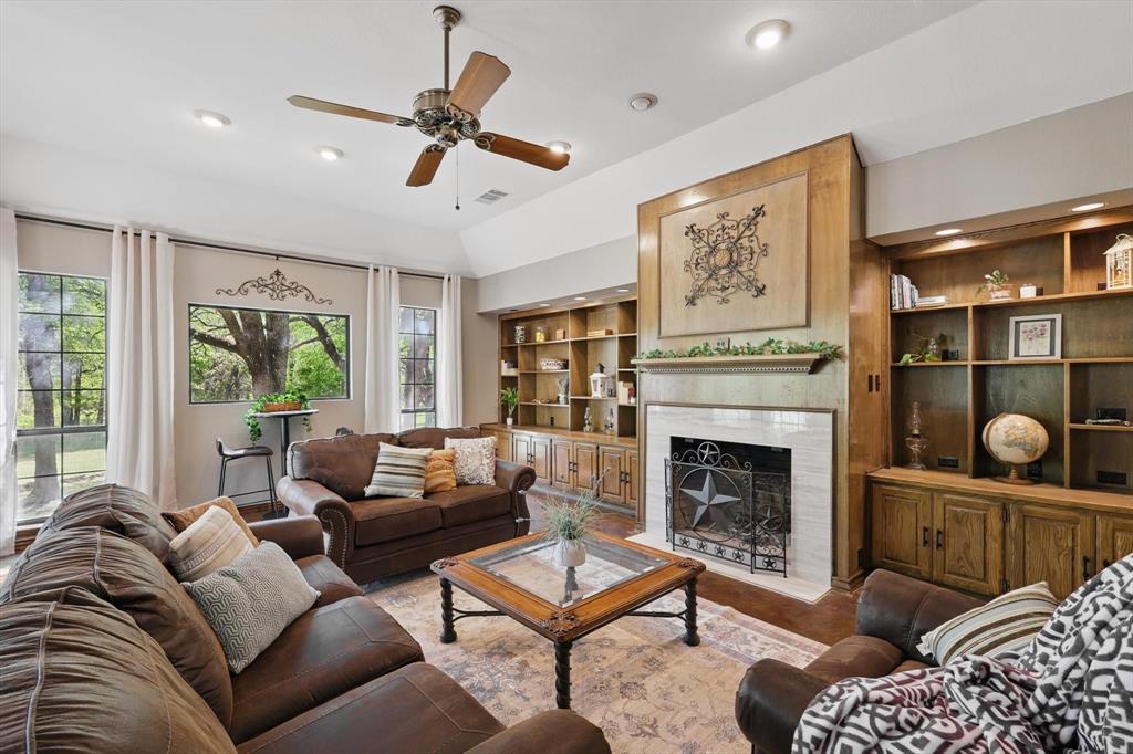1904 Oak Ridge Trail Bridgeport, TX 76426 - Photo 8 of 34 Living area with ceiling fan, built in shelves, a high end fireplace, and recessed lighting