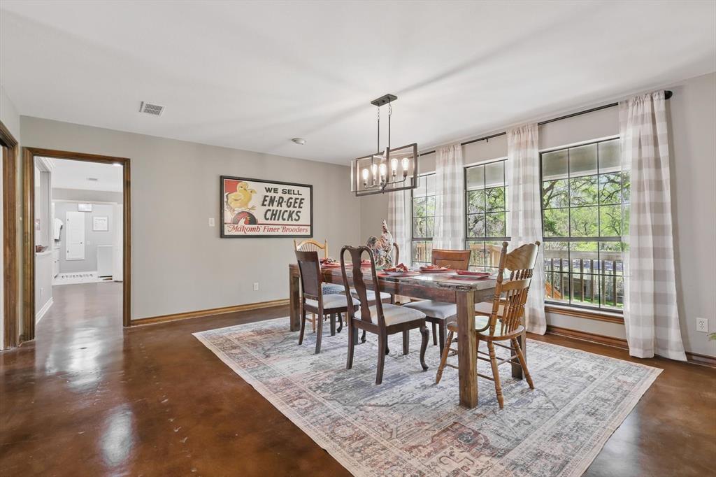 1904 Oak Ridge Trail Bridgeport, TX 76426 - Photo 10 of 34 Dining room featuring concrete flooring and a chandelier