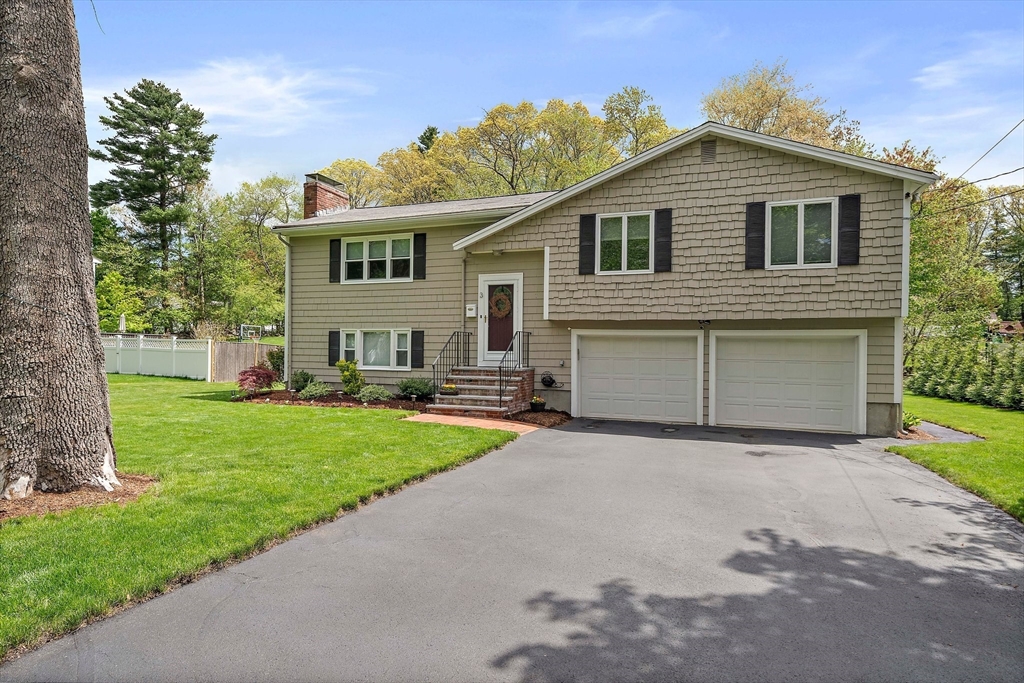 3 Burke Drive Canton, MA 02021 - Photo 2 of 39 a front view of a house with a yard and garage