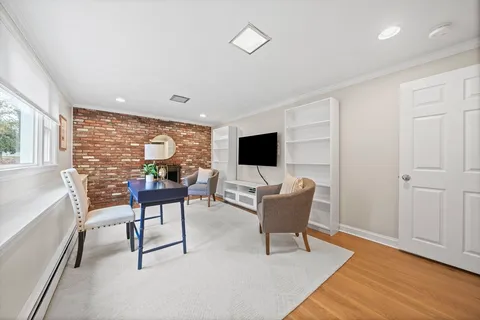 a view of a livingroom with furniture window and wooden floor