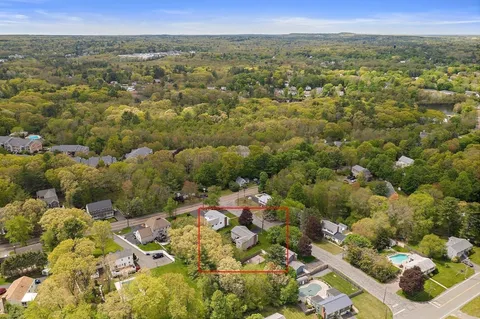 an aerial view of residential houses with outdoor space