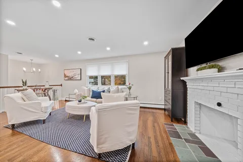 a living room with furniture a flat screen tv and a rug