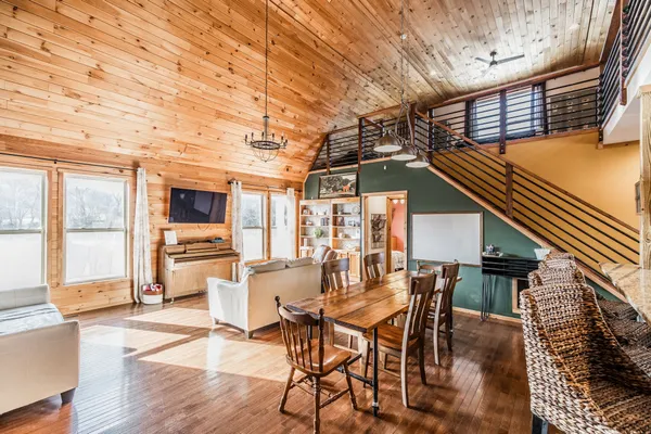 a dining room with furniture and a floor to ceiling window