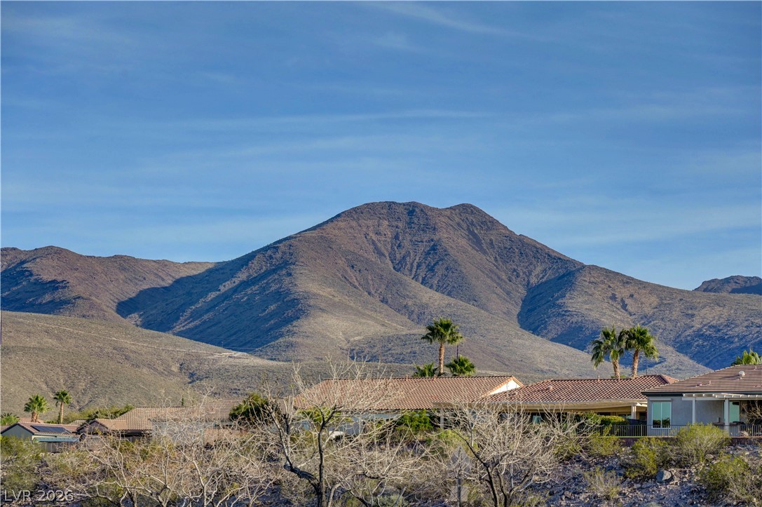 2529 Springville Way Henderson, NV 89052 - Photo 62 of 70 Dramatic mountain ridges form a majestic backdrop rising above tiled rooftops and palm trees.