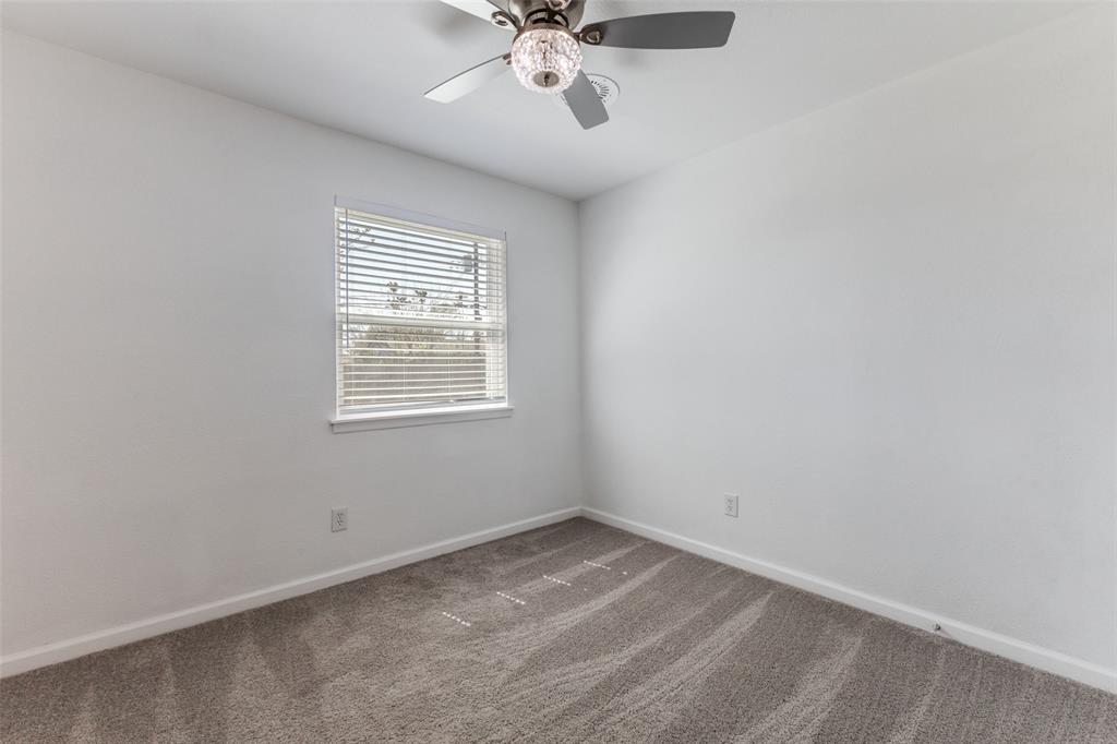 2950 Windmill Lane Farmers Branch, TX 75234 - Photo 14 of 25 an empty room with a window and a fan