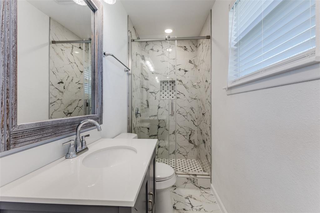 2950 Windmill Lane Farmers Branch, TX 75234 - Photo 22 of 25 a bathroom with a sink a toilet and shower