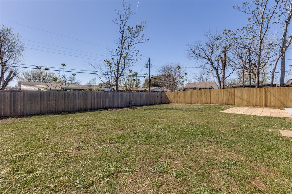 2950 Windmill Lane Farmers Branch, TX 75234 - Photo 25 of 25 a view of a backyard with large tree and wooden fence