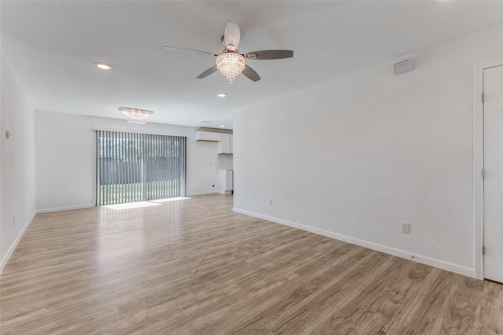 2950 Windmill Lane Farmers Branch, TX 75234 - Photo 7 of 25 a view of an empty room with wooden floor and a window