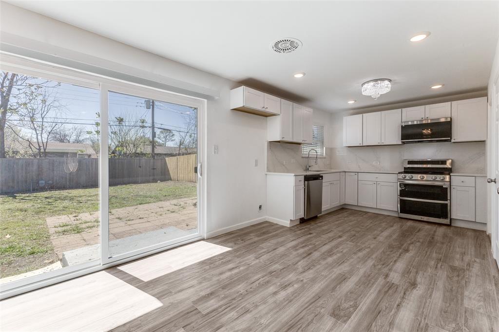 2950 Windmill Lane Farmers Branch, TX 75234 - Photo 9 of 25 a kitchen with stainless steel appliances a refrigerator and a stove top oven