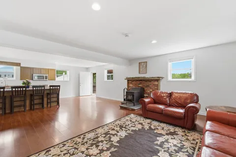 a kitchen with stainless steel appliances granite countertop a sink a stove top oven a counter space and cabinets
