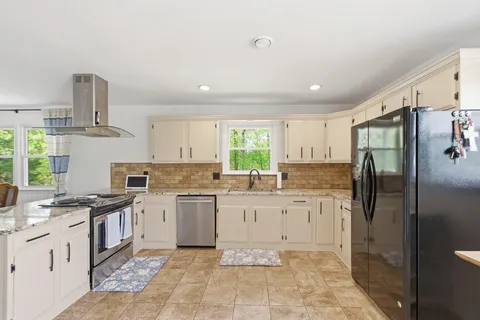 a kitchen with a sink stove and refrigerator