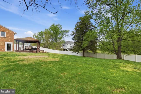 a front view of house with yard and trees