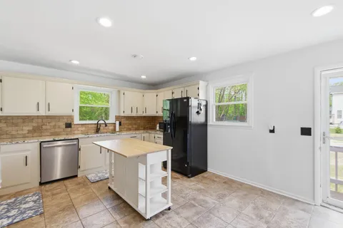 a kitchen with a sink stove and refrigerator