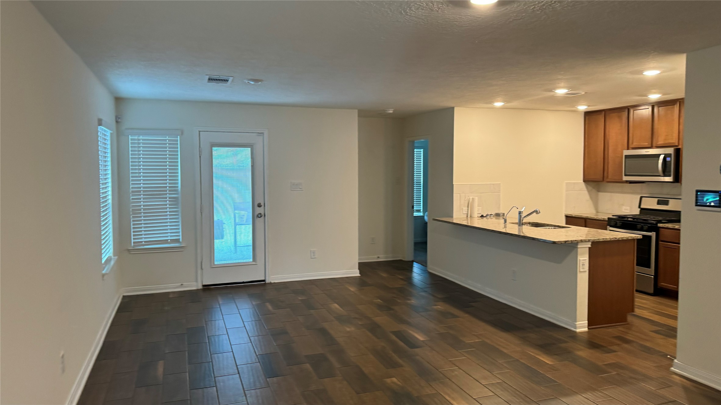 23342 Stahl Creeks Lane Spring, TX 77373 - Photo 10 of 10 a kitchen with granite countertop a stove and a refrigerator