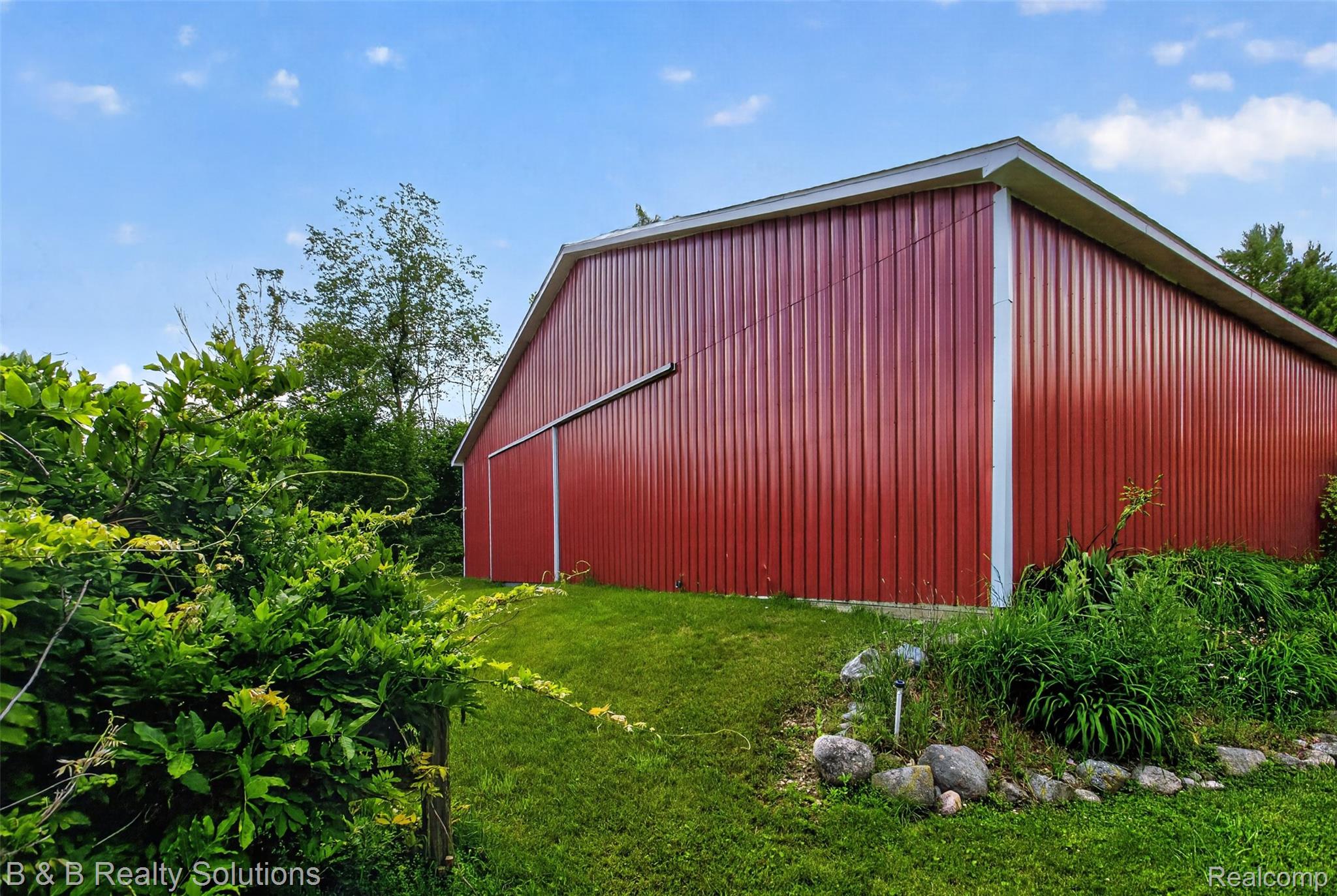 5544 Piersonville Road Columbiaville, MI 48421 - Photo 4 of 49 Red vertical panel siding barn with white trim and a sliding door