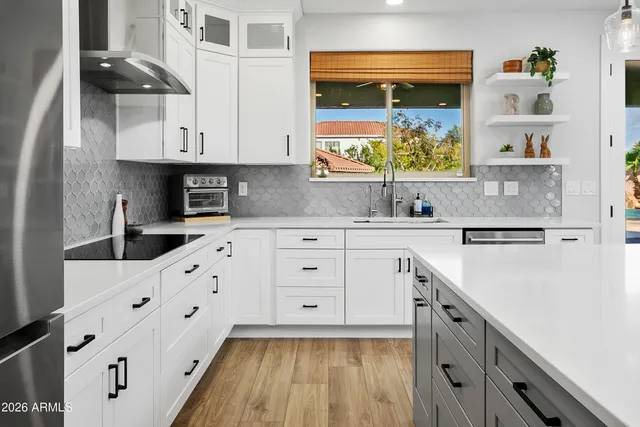 a kitchen with counter top space and wooden floor