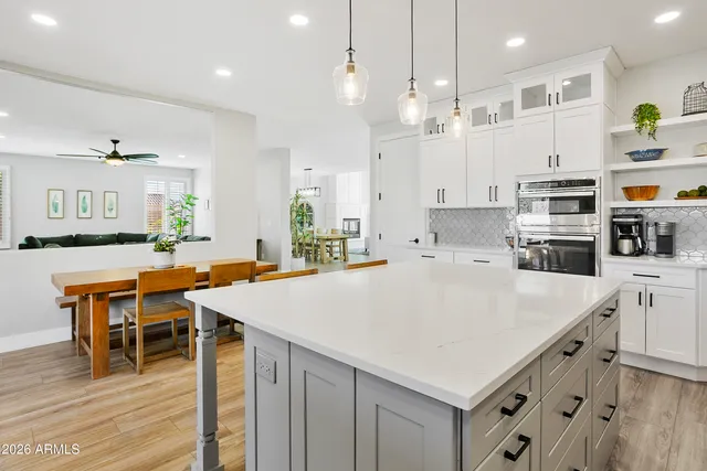 a kitchen with stainless steel appliances kitchen island granite countertop a stove a sink and a refrigerator