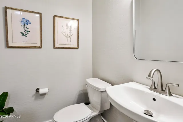 a bedroom with a bed and a ceiling fan