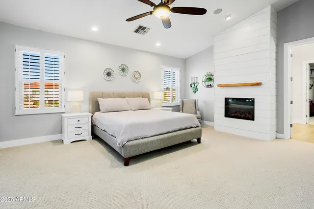 a spacious bedroom with a bed and a view of bedroom