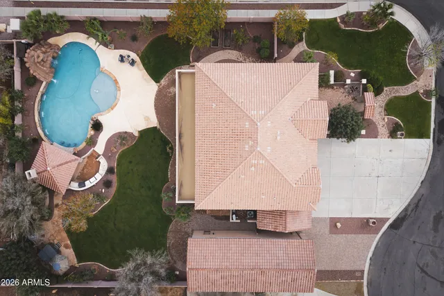 a view of a white house with a yard and large tree