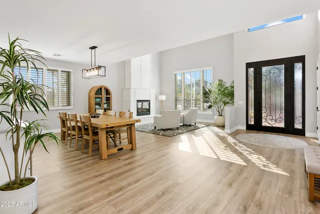 a living room with furniture a fireplace and wooden floor