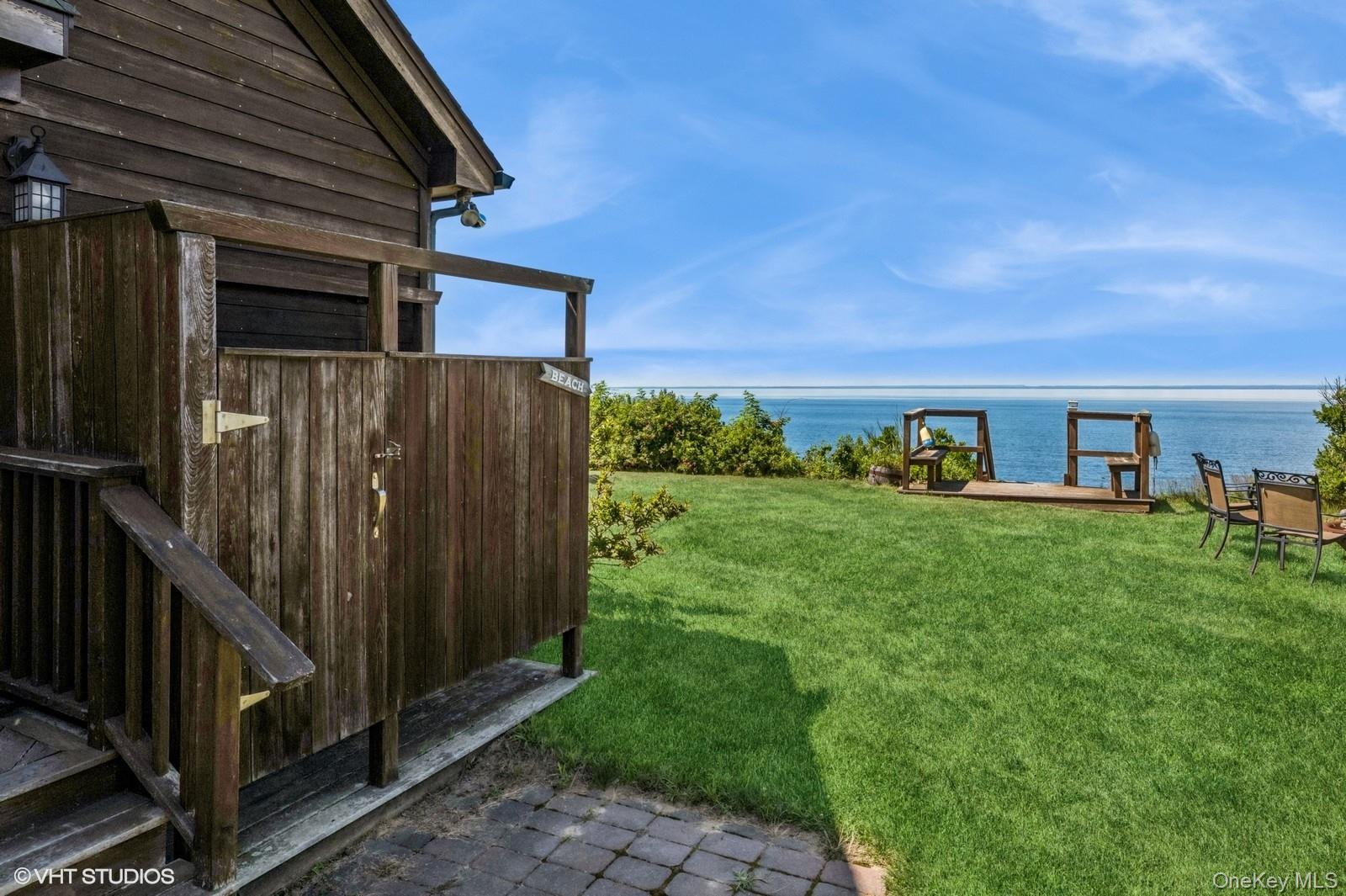 4630 Blue Horizon Bluffs Peconic, NY 11958 - Photo 4 of 13 a view of backyard with barbeque grill potted plants and wooden fence