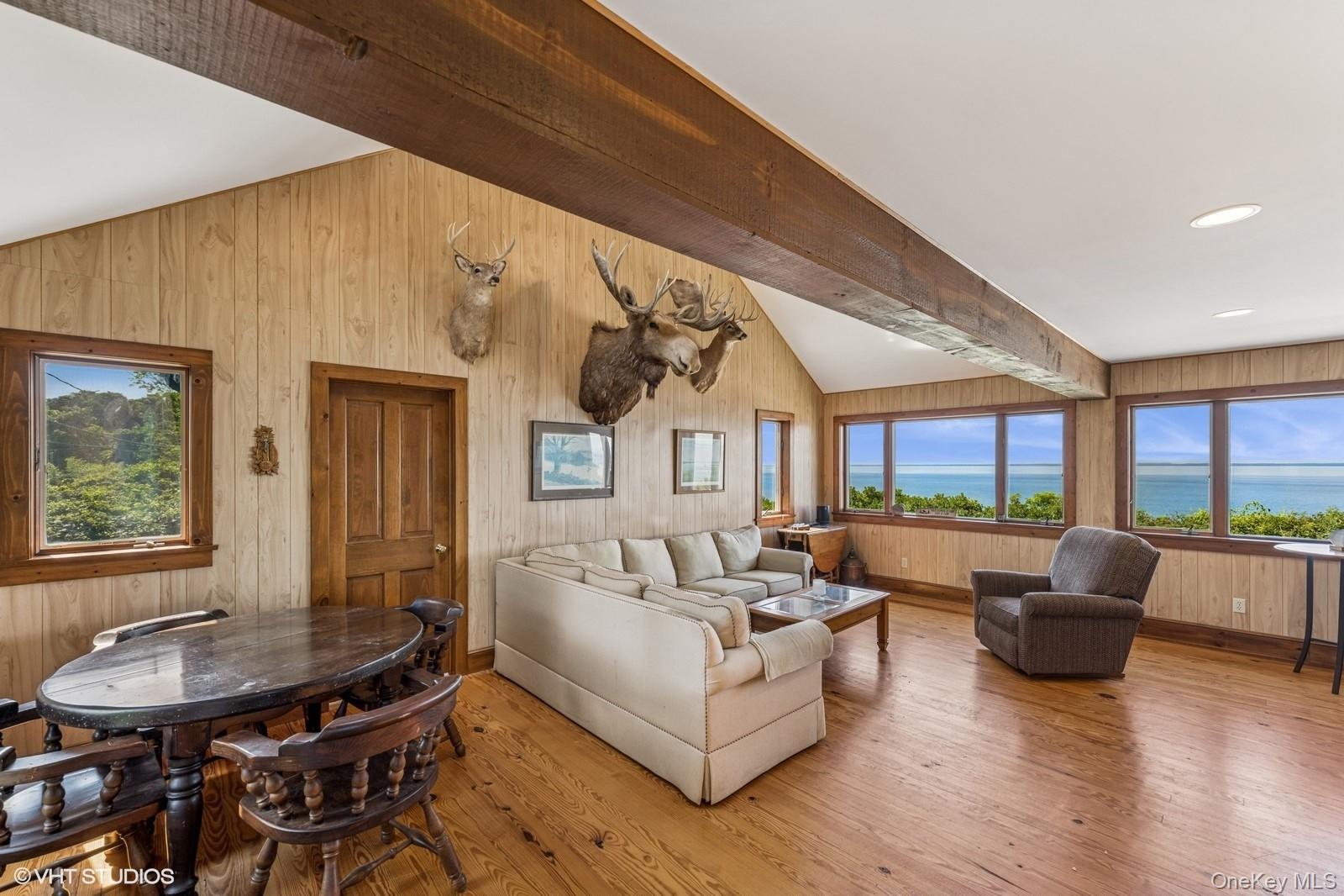 4630 Blue Horizon Bluffs Peconic, NY 11958 - Photo 5 of 13 a living room with fireplace furniture and a large window