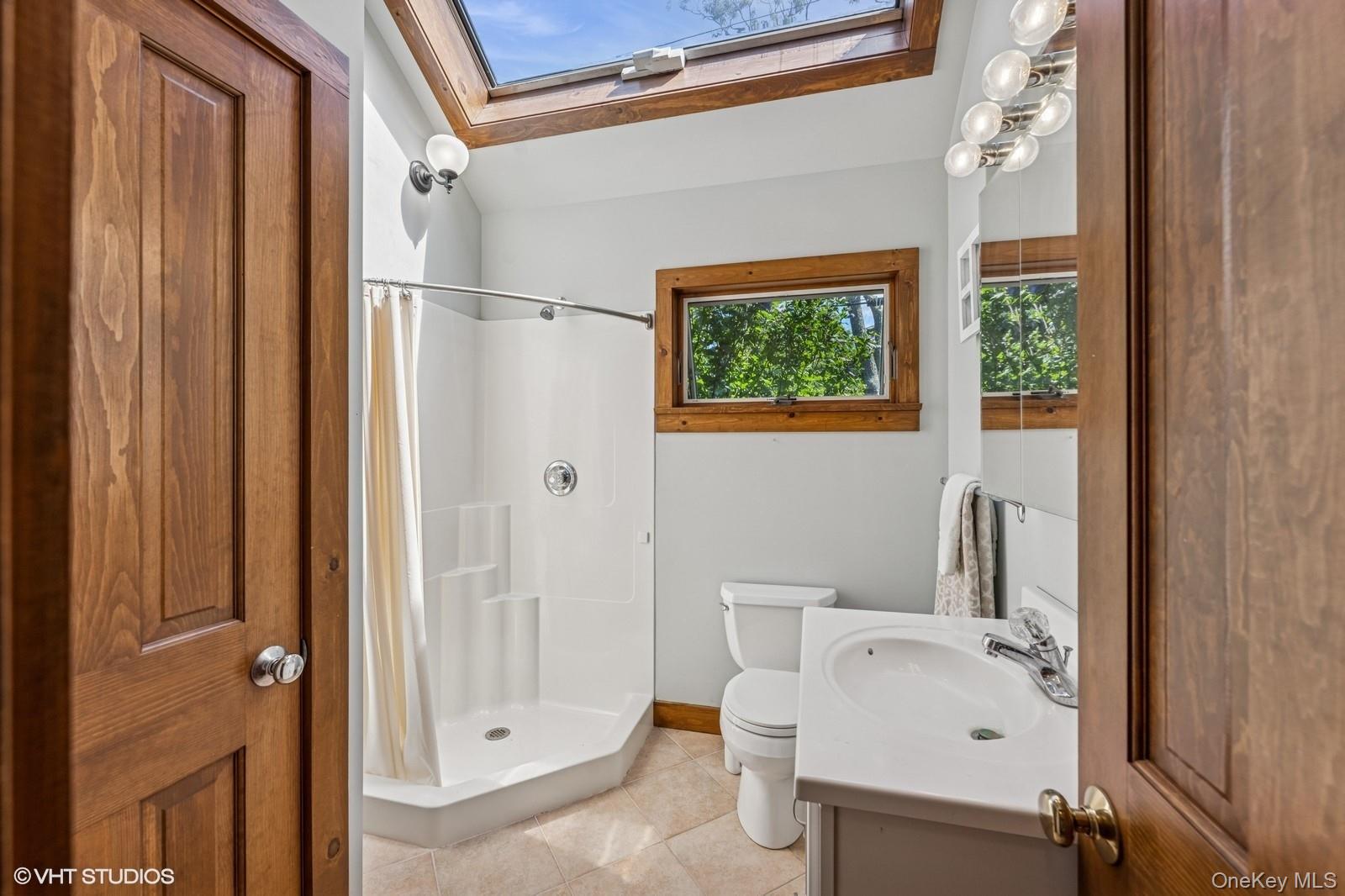 4630 Blue Horizon Bluffs Peconic, NY 11958 - Photo 9 of 13 a bathroom with a sink toilet and shower