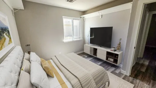 a bed sitting in a bedroom next to a window