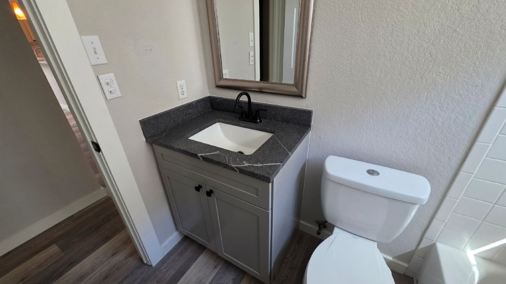 4700 Mather Kyle, TX 78640 - Photo 17 of 27 a bathroom with a granite countertop toilet sink and mirror