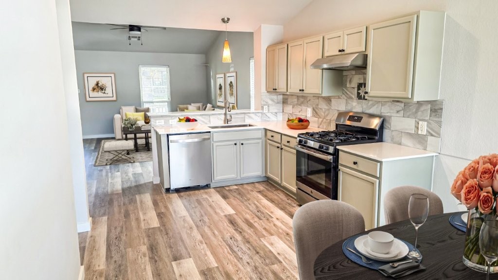 4700 Mather Kyle, TX 78640 - Photo 7 of 27 a kitchen with stainless steel appliances a white stove top oven sink and cabinets