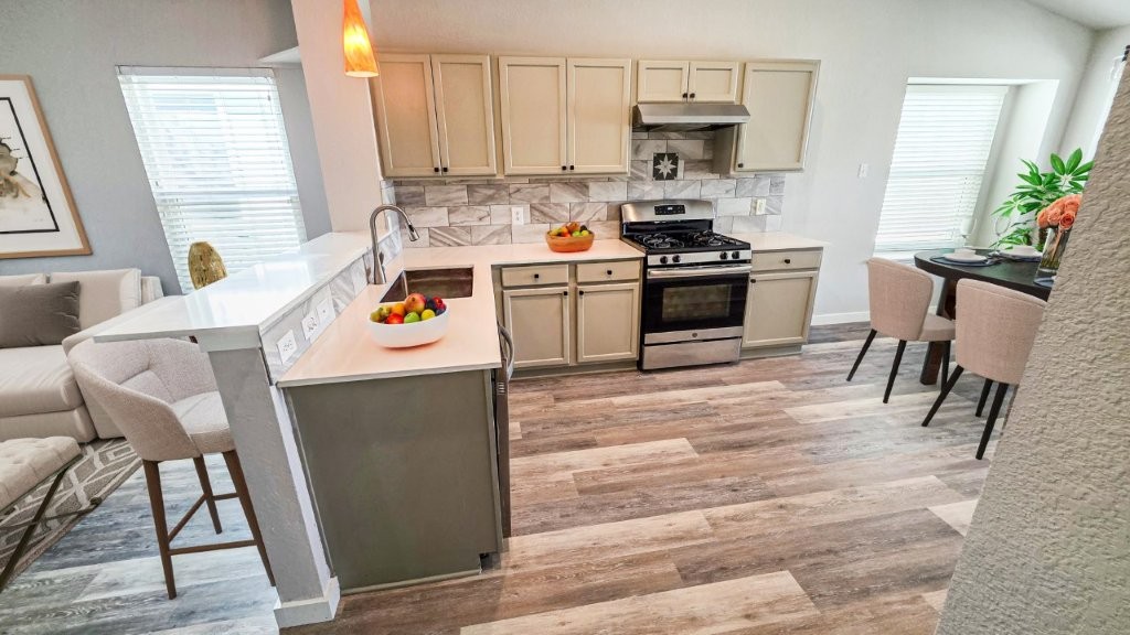 4700 Mather Kyle, TX 78640 - Photo 26 of 27 a kitchen with stainless steel appliances kitchen island granite countertop a stove a sink and a microwave