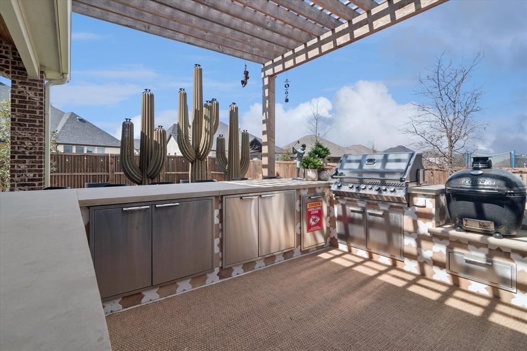 582 Broadleaf Way Haslet, TX 76052 - Photo 31 of 40 Outdoor kitchen with ample storage, built in grill, egg smoker, refrigerator, arbor.