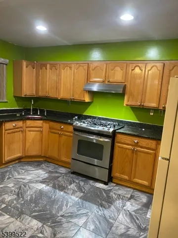 a kitchen with a sink window and cabinets