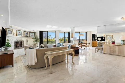 a living room with lots of furniture and kitchen view
